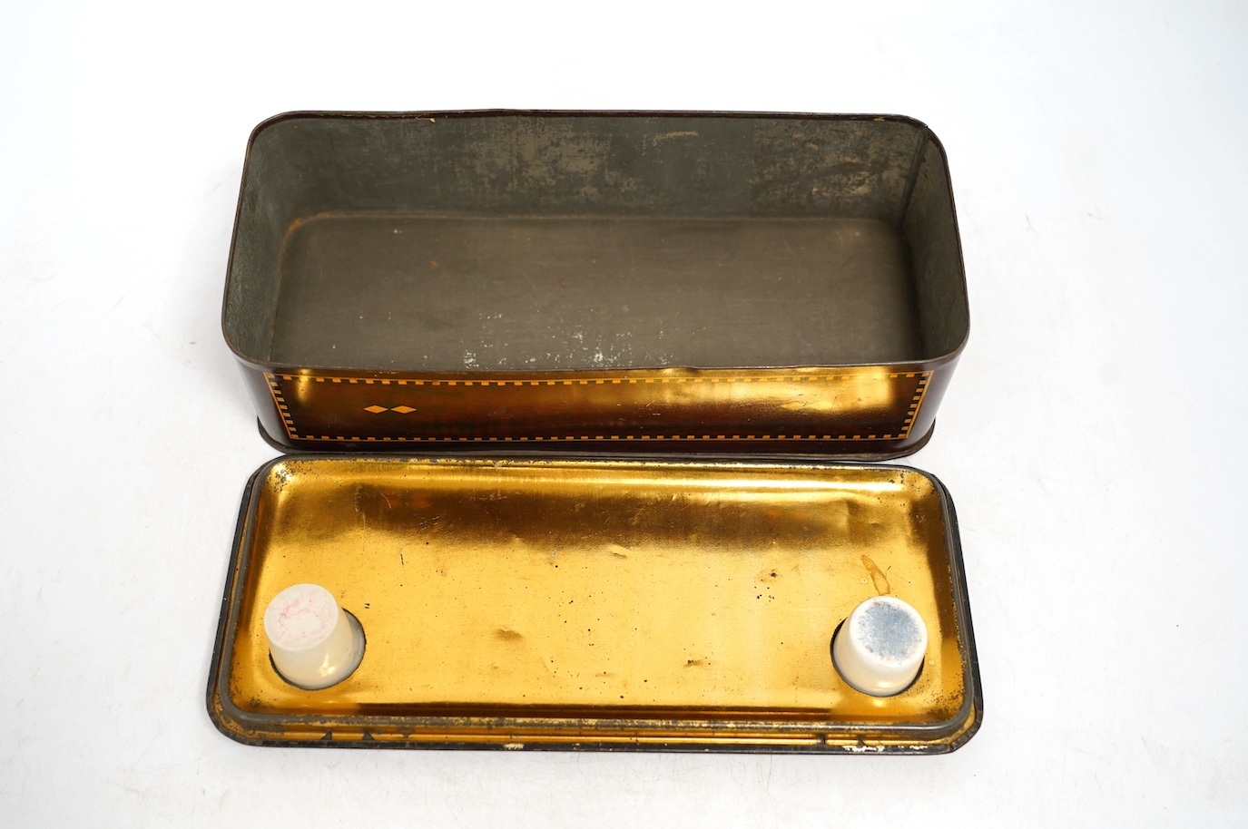 An early 20th century Carrs novelty 'dice game' biscuit tin, a Don Confectionery 'chessboard' tin and a Wright & Son Ltd inkstand tin, largest 33cm wide. Condition - fair